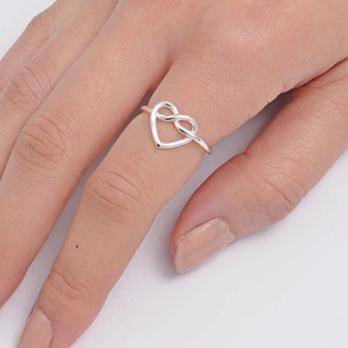 Infinity heart ring on finger