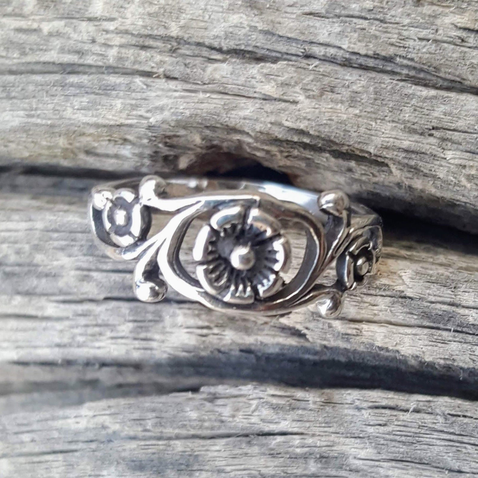 Exquisite swirling vines and leaves showcase an Irish rose.  Wear it for an everyday finger, thumb, or knuckle midi ring.  Metal quality: .925 Sterling Silver with stamped hallmark  Color: Silver  Stones: None  Face height: 7 mm high  Band width: 2 mm band  Kids and Ladies ring size: 4-10